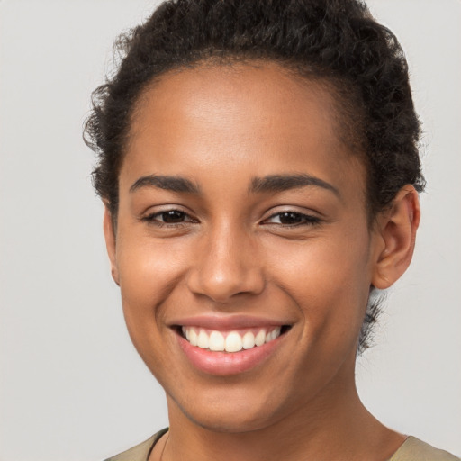 Joyful latino young-adult female with short  brown hair and brown eyes