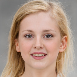 Joyful white young-adult female with medium  brown hair and blue eyes