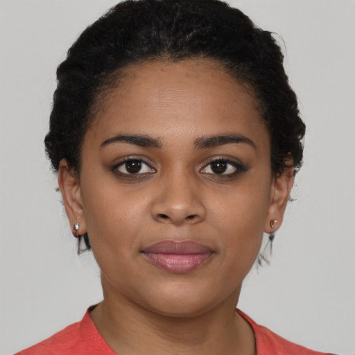 Joyful black young-adult female with short  black hair and brown eyes