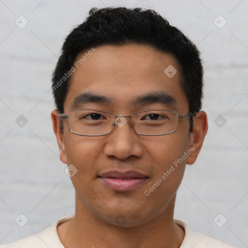 Joyful asian young-adult male with short  black hair and brown eyes