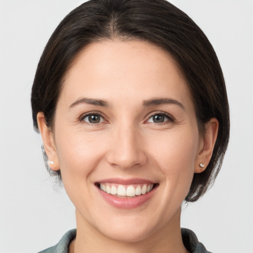 Joyful white young-adult female with medium  brown hair and brown eyes