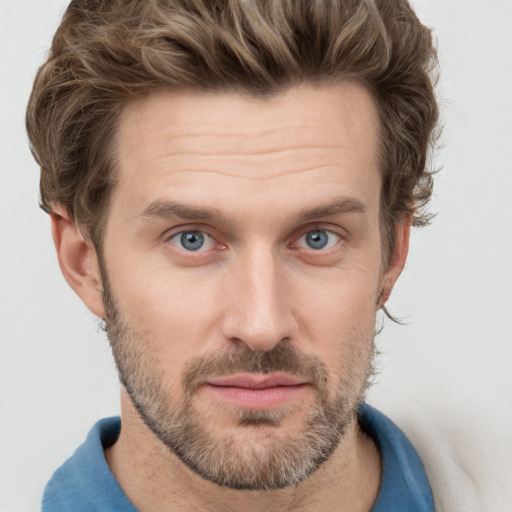 Joyful white adult male with short  brown hair and grey eyes