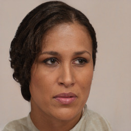 Joyful black adult female with medium  brown hair and brown eyes