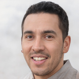 Joyful white young-adult male with short  black hair and brown eyes