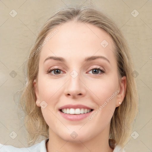 Joyful white young-adult female with medium  brown hair and blue eyes