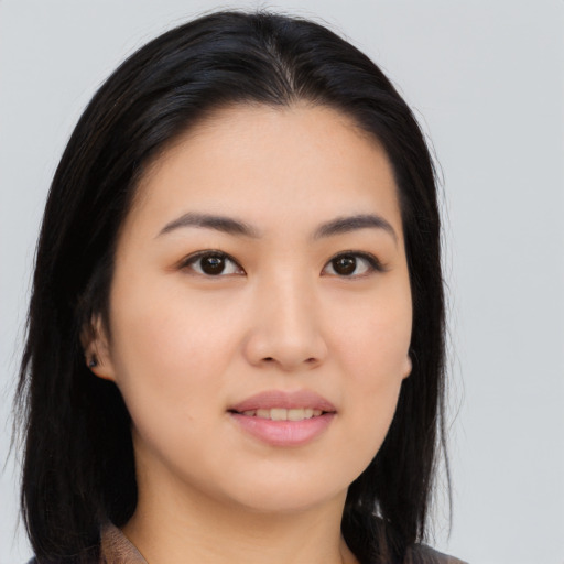 Joyful asian young-adult female with long  black hair and brown eyes