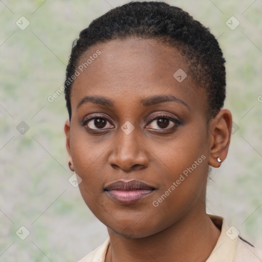 Joyful black young-adult female with short  black hair and brown eyes