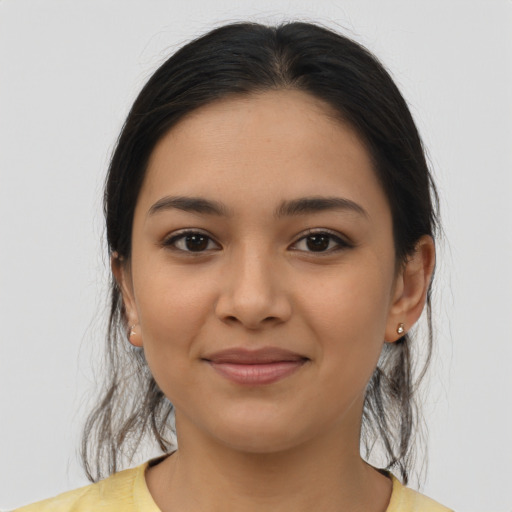 Joyful latino young-adult female with medium  brown hair and brown eyes