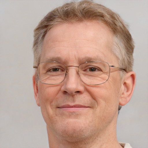 Joyful white middle-aged male with short  brown hair and blue eyes