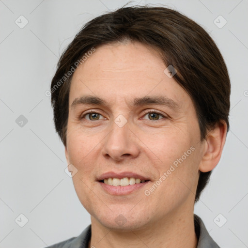 Joyful white adult male with short  brown hair and grey eyes