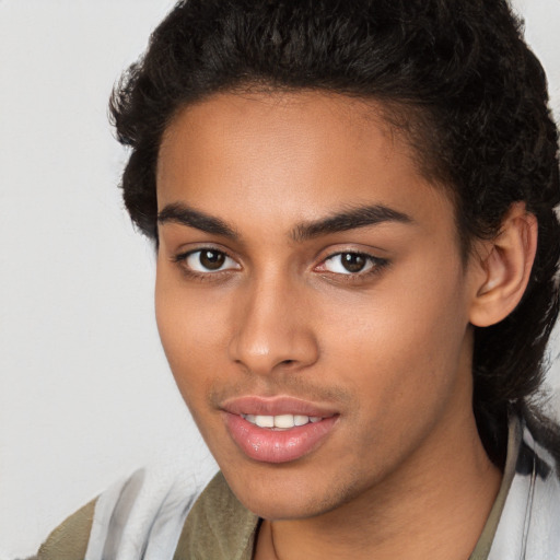 Joyful latino young-adult male with medium  brown hair and brown eyes