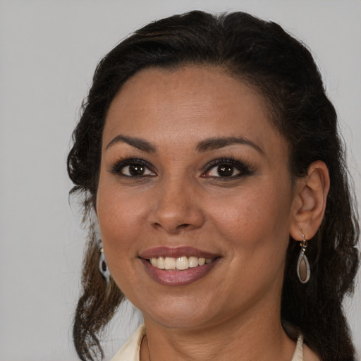 Joyful latino young-adult female with medium  brown hair and brown eyes