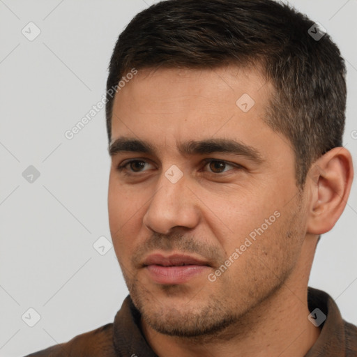 Joyful white young-adult male with short  brown hair and brown eyes