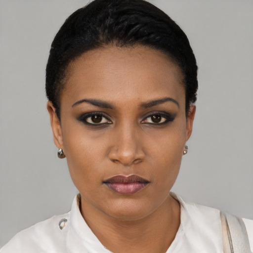 Joyful black young-adult female with short  black hair and brown eyes