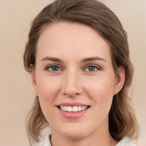 Joyful white young-adult female with medium  brown hair and green eyes