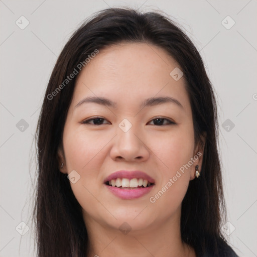 Joyful asian young-adult female with long  brown hair and brown eyes