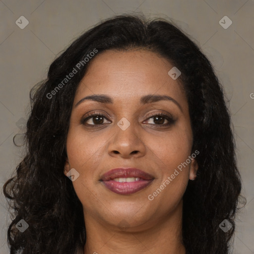 Joyful black young-adult female with long  brown hair and brown eyes