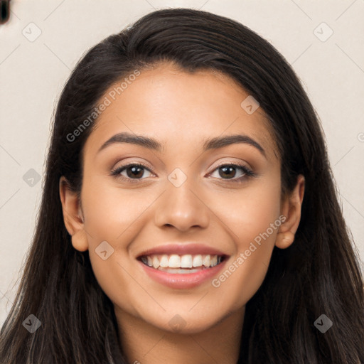 Joyful latino young-adult female with long  brown hair and brown eyes