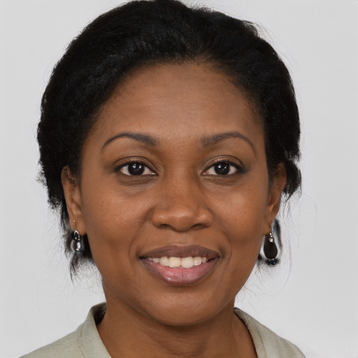 Joyful black adult female with medium  brown hair and brown eyes