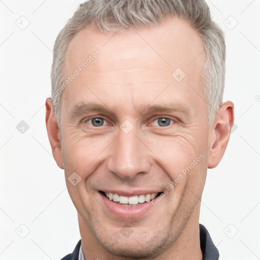 Joyful white adult male with short  brown hair and grey eyes