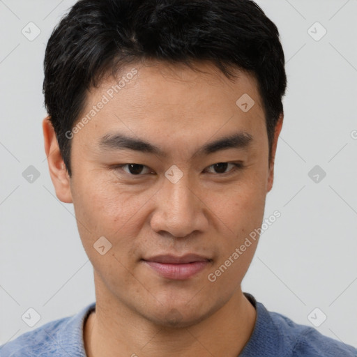 Joyful asian young-adult male with short  brown hair and brown eyes