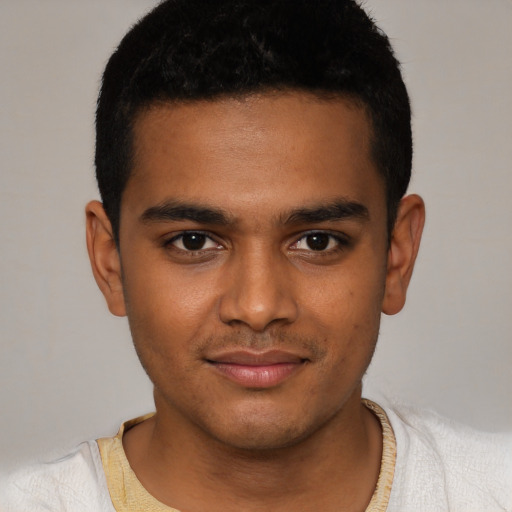 Joyful black young-adult male with short  black hair and brown eyes