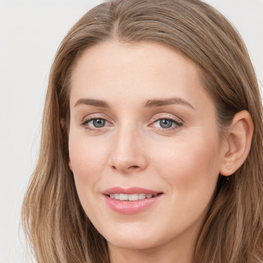 Joyful white young-adult female with long  brown hair and grey eyes