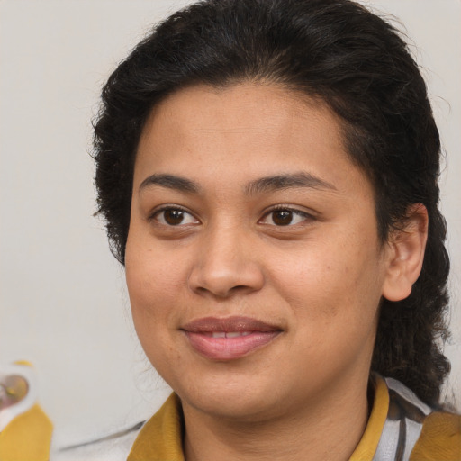 Joyful latino young-adult female with medium  brown hair and brown eyes