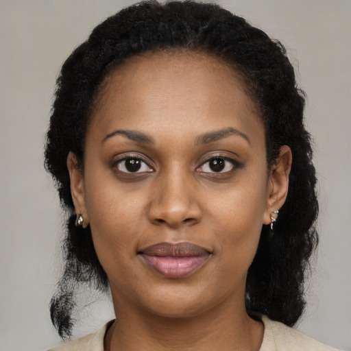 Joyful black young-adult female with medium  black hair and brown eyes