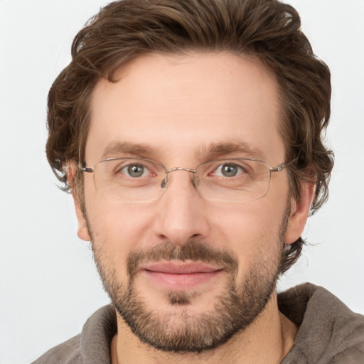 Joyful white adult male with short  brown hair and grey eyes