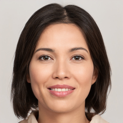 Joyful white young-adult female with medium  brown hair and brown eyes