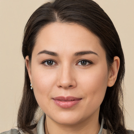 Joyful white young-adult female with long  brown hair and brown eyes