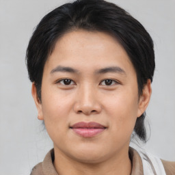 Joyful asian young-adult female with short  black hair and brown eyes