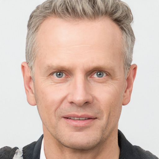 Joyful white adult male with short  brown hair and grey eyes