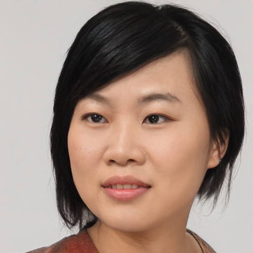 Joyful asian young-adult female with medium  black hair and brown eyes