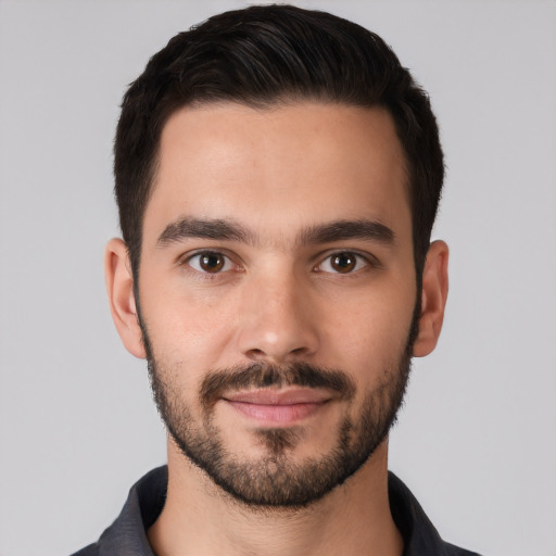 Joyful white young-adult male with short  black hair and brown eyes