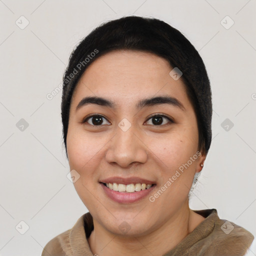 Joyful latino young-adult female with short  black hair and brown eyes