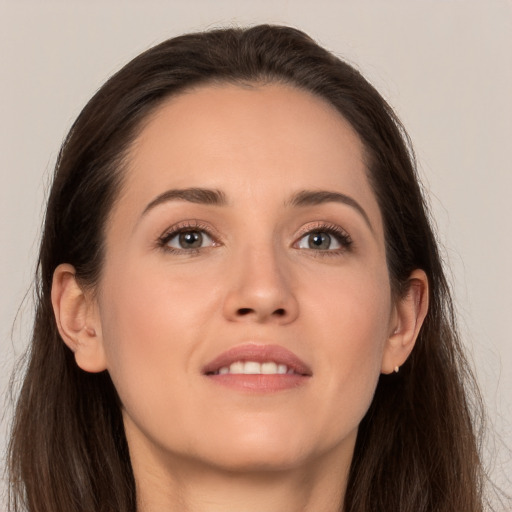 Joyful white young-adult female with long  brown hair and brown eyes