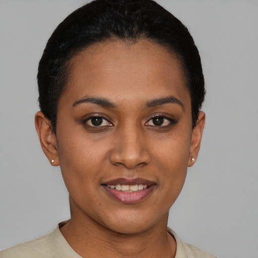Joyful latino young-adult female with short  black hair and brown eyes
