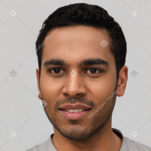 Joyful latino young-adult male with short  black hair and brown eyes