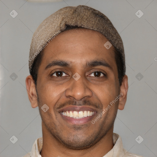 Joyful black young-adult male with short  brown hair and brown eyes