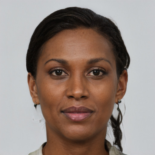 Joyful black adult female with short  brown hair and brown eyes