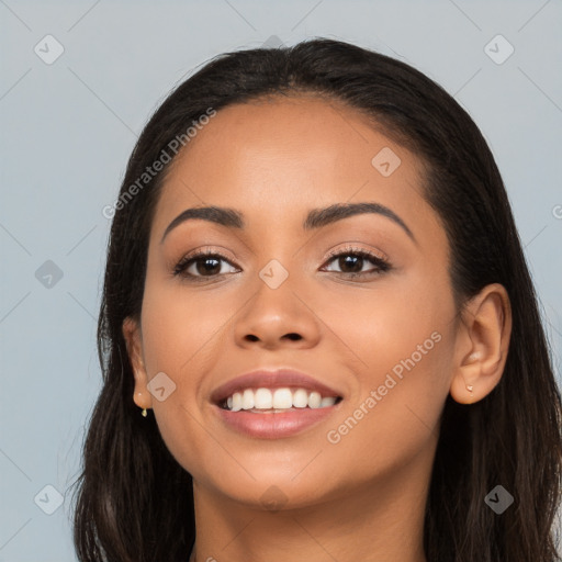 Joyful latino young-adult female with long  black hair and brown eyes