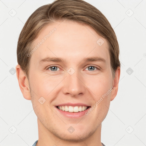 Joyful white young-adult male with short  brown hair and grey eyes