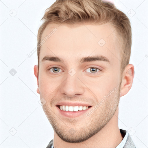 Joyful white young-adult male with short  brown hair and grey eyes