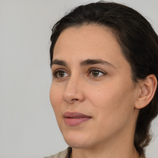 Joyful white young-adult female with medium  brown hair and brown eyes