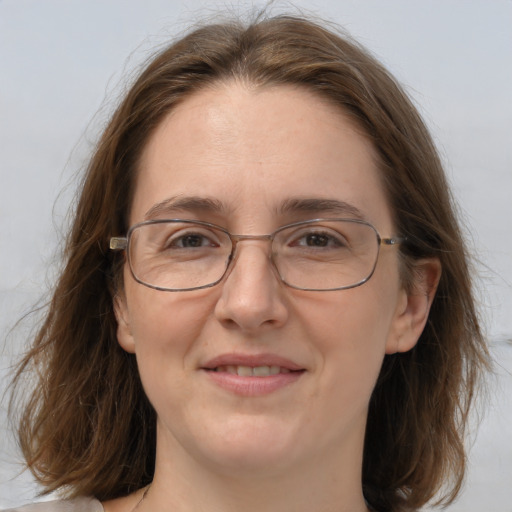 Joyful white adult female with medium  brown hair and brown eyes