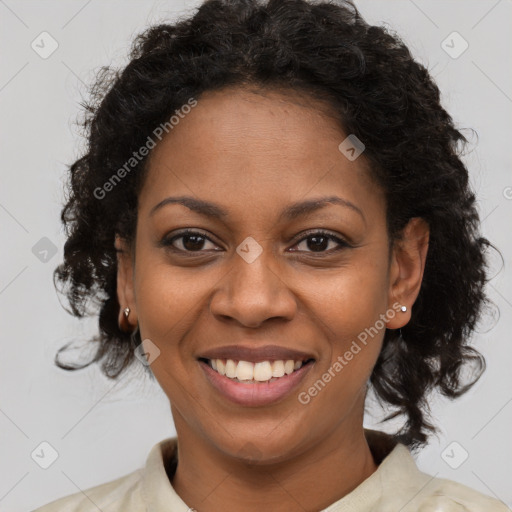 Joyful black young-adult female with long  brown hair and brown eyes