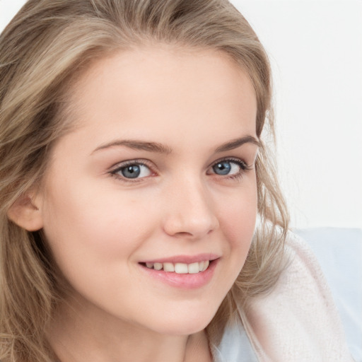 Joyful white young-adult female with long  brown hair and blue eyes