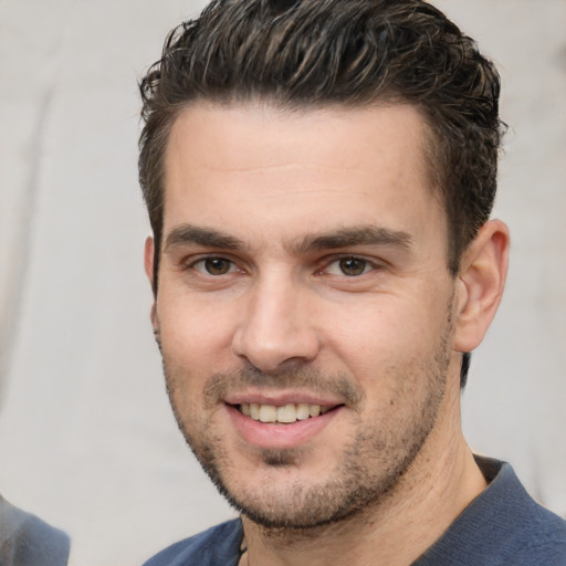 Joyful white young-adult male with short  brown hair and brown eyes